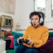 Portrait of a young African American woman playing video games at home and having fun.